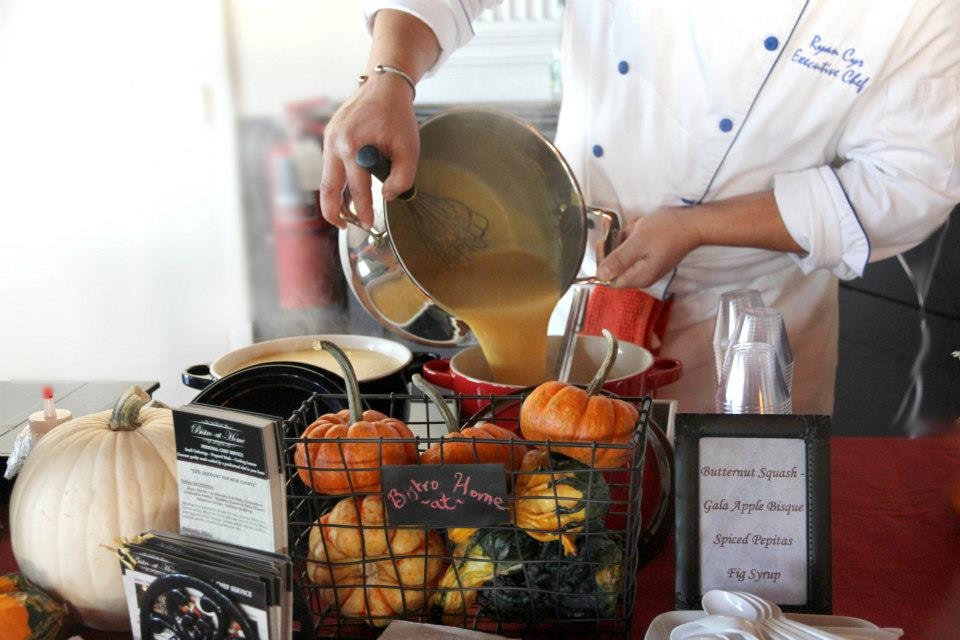 Chef Ryan Cyr pouring soup into bowls